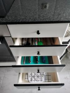 a drawer in a kitchen counter with someones items at Piso Pauser in Puentecesures +19 photos