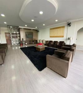 a waiting room with couches and a stage in a building at Hotel Itamaraty in Curitiba