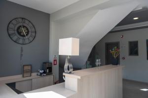 a room with a staircase with a lamp and a clock at Charisma Luxury Suite & Rooms in Pérdika