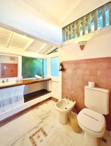 a bathroom with a toilet and a sink at Casas D'Água Doce - Casa Bambu in Ilhabela +60 photos