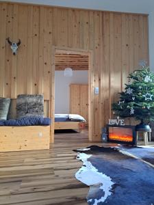 a bedroom with a christmas tree and a fireplace at Erlebnisbauernhof Gutschi Ranch in Kamp