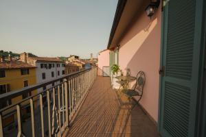 a balcony with a table and chairs on a building at [Attico Dogliani] vista Langhe in Dogliani