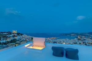 a room with a view of the city at night at ArtdecoSyros Superior in Ano Syros
