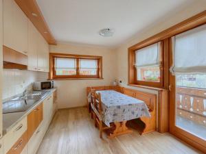 a kitchen with a table and a table and chairs at Skyrim Apartment - City Centre in Livigno