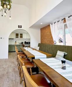 a dining room with wooden tables and chairs at Casa Elia in Bran
