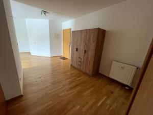 an empty room with a door and a wooden floor at Großes Apartment im DG in Leipzig