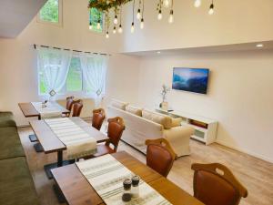 a living room with a couch and tables and chairs at Casa Elia in Bran