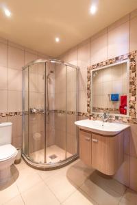 a bathroom with a shower and a sink and a toilet at Hill View Hotel Apartments in Pissouri