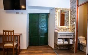 a bathroom with a green door and a sink at Estancia San Pedro Hotel in Cusco +61 photos