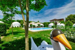 a statue of a duck next to a swimming pool at Seagloo Glamping - Adults Only in Costinesti