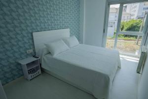 Postel nebo postele na pokoji v ubytování Apartamento con TERRAZA en Burela