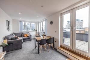 a living room with a couch and a table at City centre apartment with roof terrace. in Birmingham