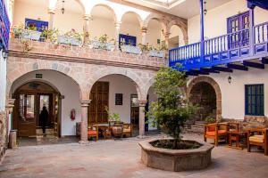 a courtyard with tables and chairs in a building at Estancia San Pedro Hotel in Cusco