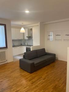 a living room with a couch and a kitchen at Casa Apolloni 40 in Fano