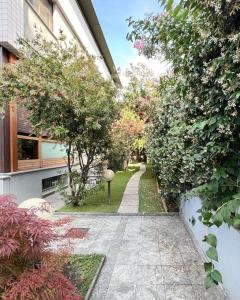 einen Garten mit einem Gehweg zwischen zwei Gebäuden in der Unterkunft Fabio's BnB in Mailand
