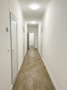 an empty corridor in an office building with white walls at Löwenbäckerei in Leipzig