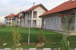 a row of houses in a yard with a street light at Countryside Resort Sarajevo in Hadžići