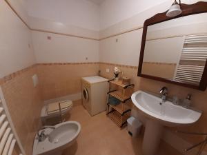 a bathroom with a sink and a toilet and a mirror at La casa di Amelia in Borzonasca