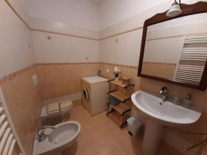 a bathroom with a sink and a toilet and a mirror at La casa di Amelia in Borzonasca +48 photos