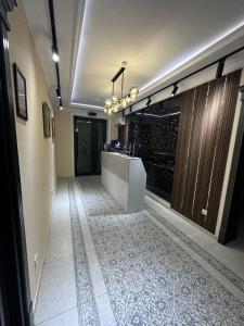 a hallway with a counter and a tile floor at NEST INN in Tashkent