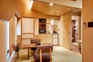 a kitchen and dining room with a table and chairs at LiveGRACE Mabuji Park Hotel - Vacation STAY 51973v in Tokyo