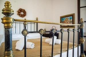 a bedroom with a bed with towels on it at Vagia Traditional, Aegina Island in Vaia