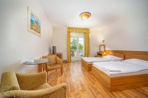 Postel nebo postele na pokoji v ubytování Nefelejcs Hotel