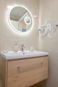 a bathroom with a sink and a mirror at Villa Michalis in Liapades