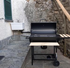 a grill sitting on a table next to a building at La casa di Amelia in Borzonasca