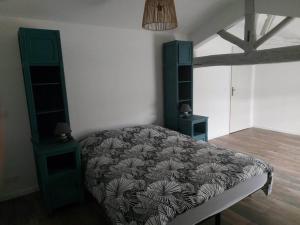 a bedroom with a bed with a blanket on it at LA MAISON D'AUXANNE in Giffaumont-Champaubert