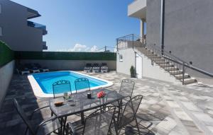 a patio with a table and a swimming pool at Holiday home Split in Split
