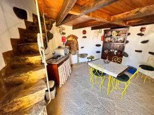 a kitchen with a table and chairs in a room at Moinho do Monte Branco in Castro Verde