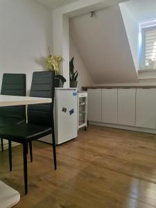 a room with a table and chairs and a kitchen at Zakątek u Natalii in Lubawka