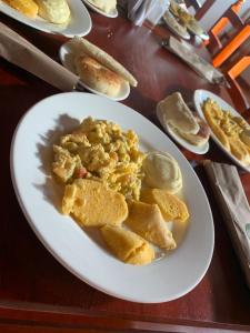 a white plate with food on a table at Bohemia Hotel Boutique in Mompos