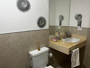 a bathroom with a toilet and a sink at Departamento de Categoria Torre Costanera Norte, Corrientes in Corrientes +16 photos