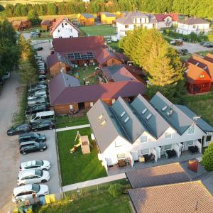 an overhead view of a building with cars parked in a parking lot at Morelowe Domki in Mielenko