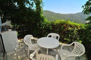 a white table and chairs sitting on a stone patio at Chrissafis Hotel in Panagia