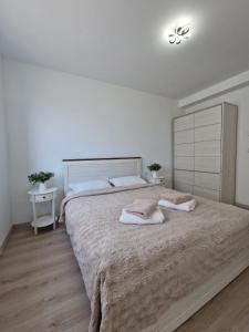 Ένα ή περισσότερα κρεβάτια σε δωμάτιο στο San Casa Apartment