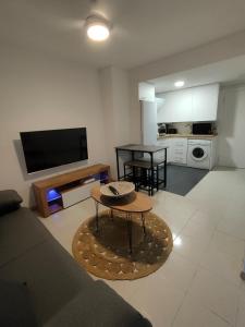 a living room with a couch and a table at Apartamentos Garmen en Benicàssim in Benicàssim