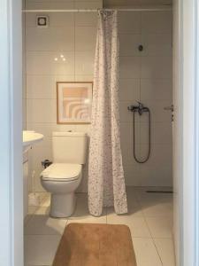 a bathroom with a toilet and a shower at Etern Stays IEG - Pristine Apartment in Prishtinë +14 photos
