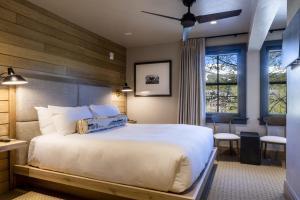 a bedroom with a large white bed and a desk at Inn at the Carlin in Breckenridge