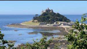 a castle on top of an island in the ocean at Penzance Cottage in Penzance