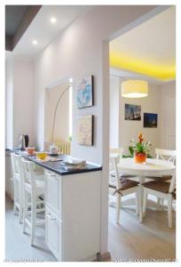 a kitchen and dining room with a table and chairs at Santa Chiara Apartment in Turin