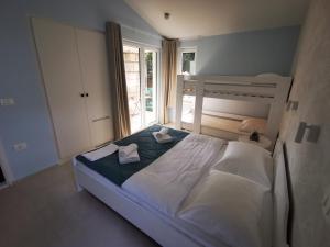 1 dormitorio con 1 cama con 2 toallas en Morski gaj Resort, en Piran