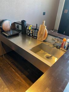 a kitchen counter top with a sink and a counter top at tiny resort misawa - Vacation STAY 14682 in Misawa
