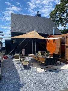 a large tent with chairs and a table in front of a building at tiny resort misawa - Vacation STAY 14682 in Misawa