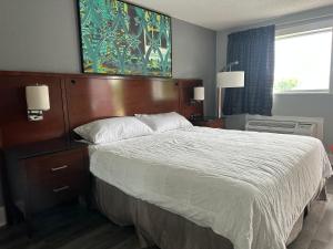 a bedroom with a large bed with a wooden headboard at Courtland Inn in Courtland