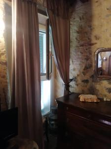 Zimmer mit einer Kommode, einem Spiegel und einem Fenster in der Unterkunft Casa Vacanza Bel Panorama Collina Versilia in Culla