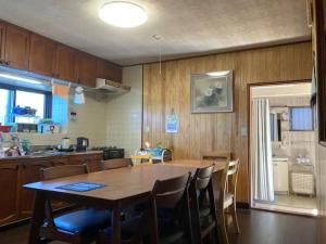 a kitchen with a large wooden table and chairs at Minpaku Yagi - Vacation STAY 14700 in Ise