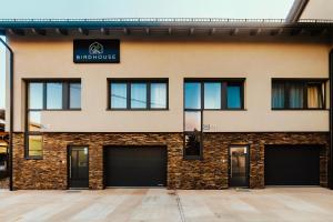 a building with four garage doors in front of it at BIRD HOUSE in Prešov